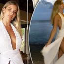 Natasha Oakley exposes privates as she wears a revealing white dress with a thigh-high split while on holiday in Fiji