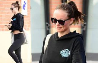 Olive Wilde braves the rain as she arrives at  the gym 