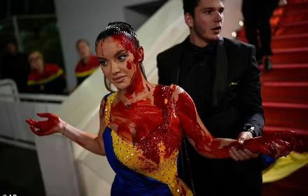 Protester in Ukrainian Flag Dress Makes Bold Statement at Cannes Film Festival with Fake Blood