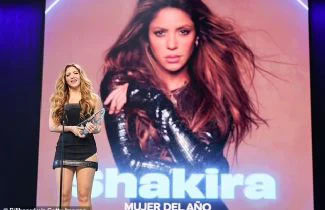 Shakira shows off  her incredible toned frame in leggy black mini dress